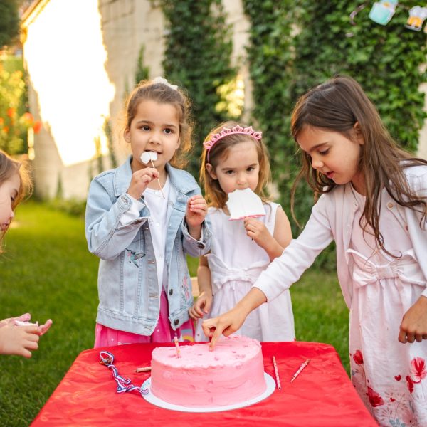 Kids enjoy cake at a joyful outdoor party